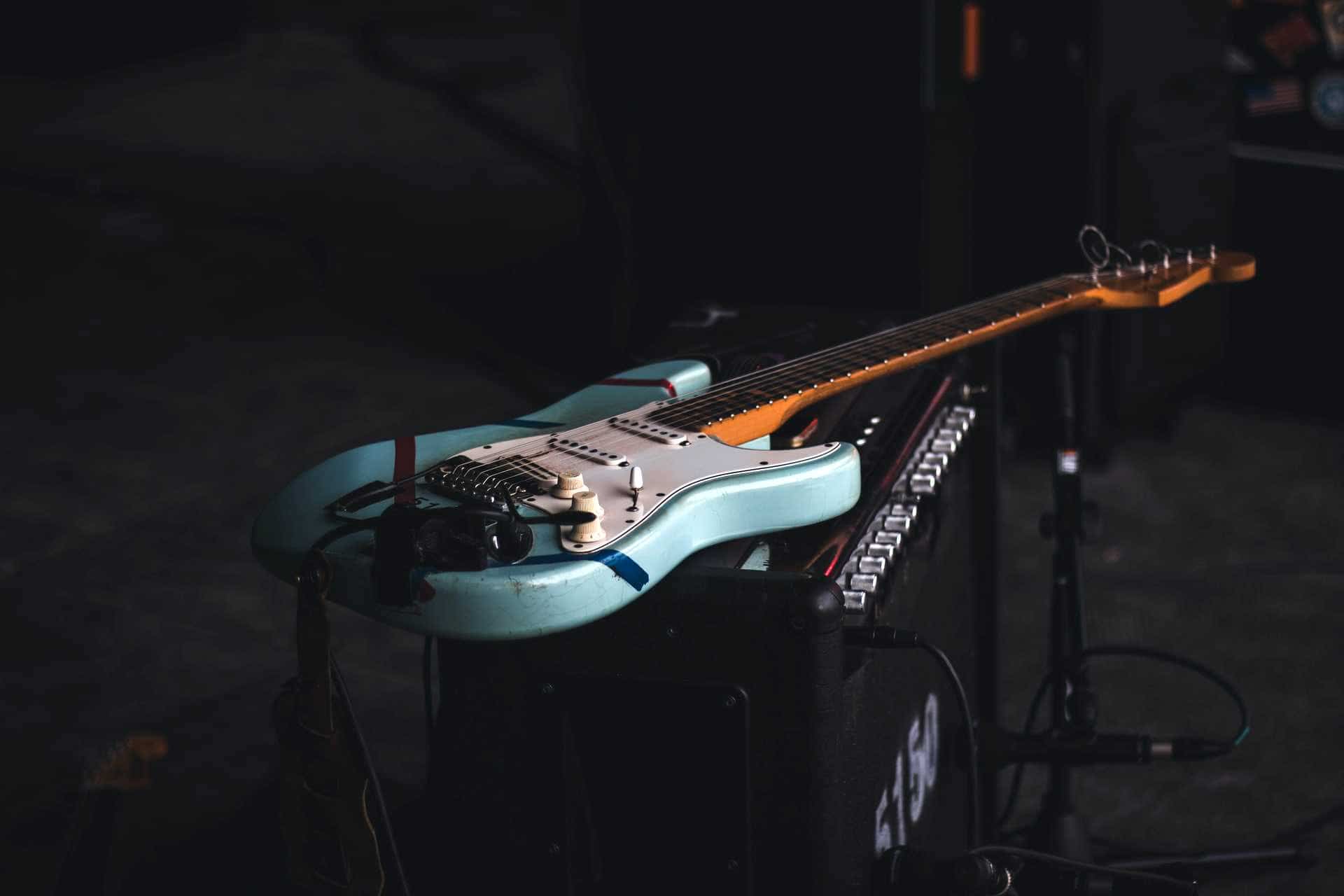 Blue Fender guitar on amp